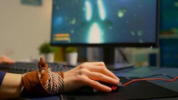 Close up of professional mouse in gaming home studio late at night. Pro gamer playing space shooter game using RGB powerful equipment for digital tournament photo
