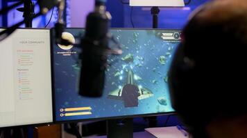 Game over for pro streamer playing online vide game space shooter in streaming room using modern headseat. Cyber performing on powerful pc talking with players on chat open during professional competition photo
