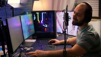 Streamer cyber performing space shooter game on powerful pc talking with players on chat open during professional competition. Player man using professional headphones in streaming home studio photo