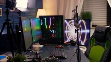 Slide view of streaming home studio equipped with professional equipment during esport competition. Gamer playing space shooter games late at night photo