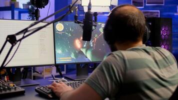 Streamer playing space shooter game , talking with other players about e-sport tournament. Winning for mock-up game r player, performing in streaming cyber studio, photo