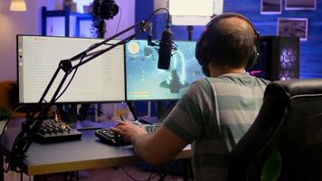 Pro esport streamer using headphones and talking with team on streaming services during space shooter competition. Virtual game in cyberspace, esports player performing on powerful computer photo