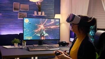 Professional player wearing vr goggles sitting on gaming chair playing online space shooter game. Defeated woman losing game tournament using joystick late at night in living room. photo
