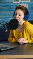 Vlogger looking at laptop and asking audience to subscribe on her channel. Online show On-air production internet broadcast host streaming live content, recording digital social media communication photo