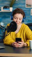 Influencer using laptop while talking with followers during live on social media. Creative online show On-air production internet broadcast host streaming live content, recording digital vlog photo