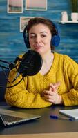 Blogger speaking about life during podcast in home studio looking at camera. Online show On-air production internet broadcast host streaming live content, recording digital social media communication photo