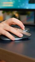 Close up hands shot of gamer pushing the keyboard buttons while playing online shooter game. Virtual championship in cyberspace, esports player performing on pc during gaming tournament photo
