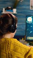 Esport of pro gamer wearing headset playing game with new graphics during championship sitting at home. Virtual shooter game in cyberspace, esports player performing on pc gaming tournament photo