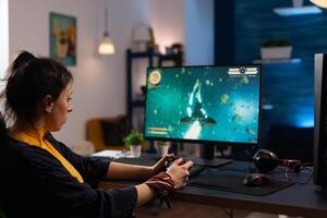 Adult playing games with controller on computer. Cheerful woman using joystick to play online game on internet. Player doing fun activity in cyber space with gaming equipment. photo