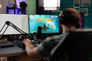 Player winning gameplay with live chat on stream. Man streaming and playing games, celebrating win on computer. Gamer using microphone and headset while he is live streaming. photo