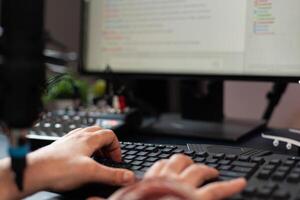 Close up of man using keyboard on live stream chat. Person streaming online on computer, using control keys to talk to audience. Streamer broadcasting gameplay with modern equipment photo