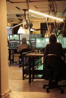 Hackers planting computer malware on software, cracking database password and stealing information for ransom. Having access to online server illegally, cybercrime at night time. photo