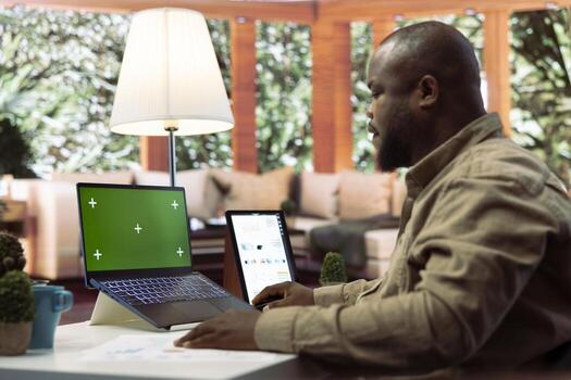 Financial adviser works with infographics next to a copy space mockup display, using accounts balance to create a correct economic report. Entrepreneur examines business data. photo