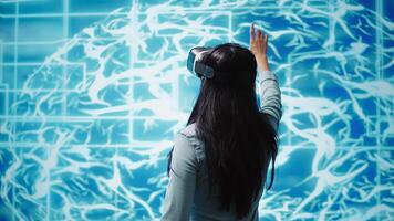 Developer wearing VR headset looking at hologram of artificial intelligence human brain simulation. Programmer interacting with AI visualization showing machine learning algorithms, camera B photo