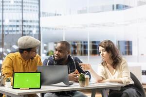 Business partners negotiating with woman realtor next to mockup, entrepreneurs looking to invest in high class urban office space. Clients examining architectural blueprints plans. photo