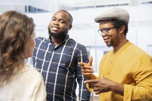 Entrepreneurs and salesman evaluating office space layout during a tour, reviewing blueprints, and discussing leasing and real estate investment opportunity. Development strategy. photo