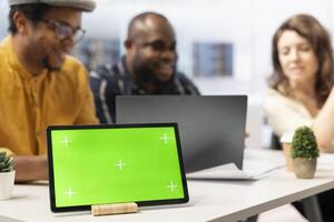 Real estate agent presenting urban building layout next to green screen, discussing about a high class office space leasing for business relocation. Clients looking to invest in property. photo
