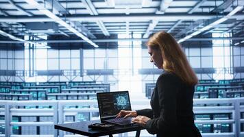 Admin in data center works with artificial intelligence computerized model simulating human brain. Employee working on notebook with AI machine learning algorithms using pattern recognition, camera B photo