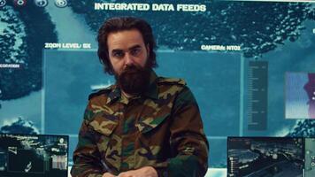 Officer analyzes intelligence reports to anticipate enemy movements and adjust strategies accordingly. Monitoring real time battlefield data to provide critical updates to commanders. Camera B. photo