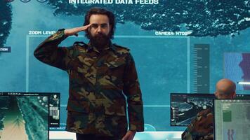 Sergeant presenting his salute with respect for the colonel and high ranking military officers, saluting the captains while he works on intelligence in command center, pride and duty. Camera A. photo