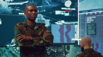 Portrait of confident military general wearing camo uniform in mission control center, overseeing operations regarding the national safety and protocol. Federal army base command post. Camera A. photo