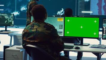 Woman operator works with isolated display and tracking enemy vessels, transmitting gps coordinates to the national guard headquarters. Female soldier operates on CCTV system. Camera A. photo