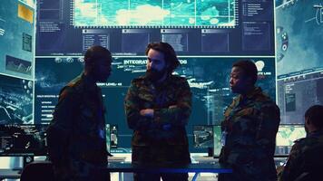 Brigadier general and his staff studying radar data on a holographic image, working with artificial intelligence and holography in a military base of operations. Ensure national safety. Camera B. photo