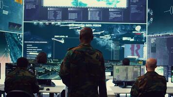 General headquarters under ruling of army IT professional that reviews insight about a new national safety mission. Command sergeant major briefing his marine corps troops with big data. Camera B. photo