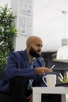 Arab financial manager working on laptop, analyzing data and developing strategies for company. Start up entrepreneur creating business plan and solving complex task in coworking space photo
