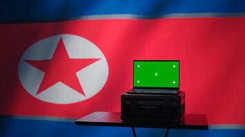 Isolated screen laptop in Pyongyang intelligence command center used by dictatorship party to run security protocols against NATO and South Korea enemies, isolated over North Korea flag, camera B photo