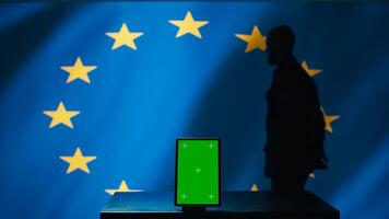 European Union counterintelligence division uses green screen tablet to protect against propaganda affecting elections. EU security service safeguarding democracy online using mockup device, camera B photo