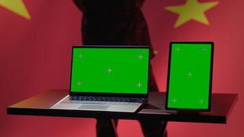 China army soldier using isolated screen laptop and tablet to identify threats from enemies. Army personnel using software on chroma key devices to relay info to war front lines, camera A photo