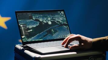 European Union using radar system on laptop to detect incoming ballistic missiles attacking member states. EU alliance army soldier scanning rockets approaching countries, deploying shields, camera A photo