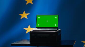 EU alliance engineer uses green screen laptop to protect against fake accounts on social media. Technician doing cybersecurity job for European Union with mockup notebook, camera A photo