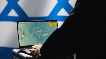 Iranian spy in control room uses military tech to identify threats during Arab Israeli conflict. Mossad intelligence agent uses software to relay info to generals on war front line, camera A photo