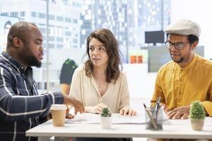 Professional brokers and client discussing rental investment strategy during an office tour, evaluating architectural blueprints for a high class corporate office space. Workspace relocation. photo