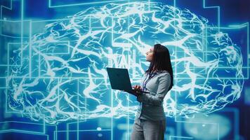 Technician using laptop to maintenance artificial intelligence neural networks made up of interconnected nodes layers. Admin using AI system aiding in processing and transmitting information, camera B photo