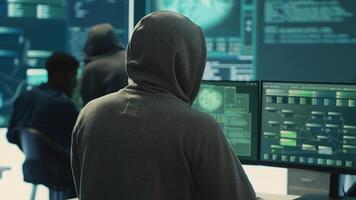 Cyber security specialist conducting cyber surveillance and threat detection in a governmental agency. Professional hackers team managing cybercrime prevention and malware detection. Camera A. photo