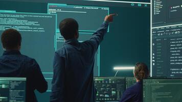 Cyber security team conducting cyber surveillance in a governmental control room. Experts group hacking activities, malware protection and data breach prevention in high tech agency. Camera A. photo