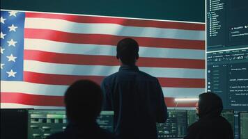 Cyber defense experts in a governmental tech room with the American flag. Working on secure computing, digital forensics and cyber operations to protect and maintain cyber safety. Camera A. photo