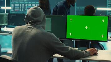 Governmental hackers working on computer with green screen to protect data and network security. Focusing on cyber defense, malware detection to prevent cyber attacks and espionage. Camera A. photo
