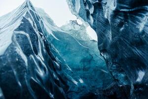 Vatnajokull ice mass at scandinavian location, containing big fragments of ice inside gap used for glacier hiking. Glacial blocks inside caves and passageways, climate change theme. photo