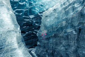 Huge chunk of fractured vatnajokull iceberg in Iceland, with iced pattern and layer of snow frost. Beautiful glaciers and ice caverns in cold, scandinavian scenery of Iceland. photo
