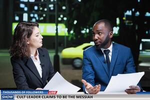 Diverse hosts worrying about cult leader calling for recruits and followers, presenters discussing about issues and daily events. Presenters team reading news headlines on live night show. photo
