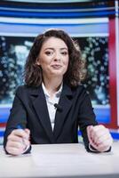 Show presenter hosting media segment to discuss about live daily events, talking about celebrities and global issues. Television host creating news report using headlines, broadcasting on tv. photo
