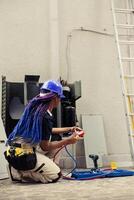 Trainer repairman preparing for routine hvac system maintenance. Competent mechanic unpacking toolkit with professional instruments needed to clean clogged air filters restricting airflow photo