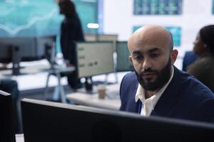 Marketing manager evaluating sales and profit within infographics data, comparing reports on a big screen. Team leader planning promotional activities for a better public image, PR tasks. photo