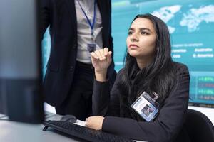 Team of analysts calculating profit amount and making decisions to fund another organizational project, examine big data on a pc. Business associates verifying productivity and budget. photo