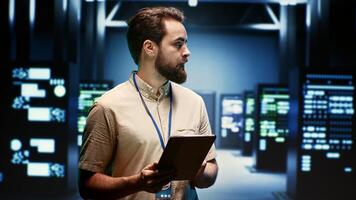 Supervisor doing routine inspection, extending high tech facility equipment life span and avoiding downtime. Manager checking data center infrastructure units for power fluctuations photo