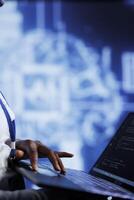System administrator writes code on laptop to visualize artificial intelligence neural networks using augmented reality, close up. High tech facility worker runs AI script for information processing photo